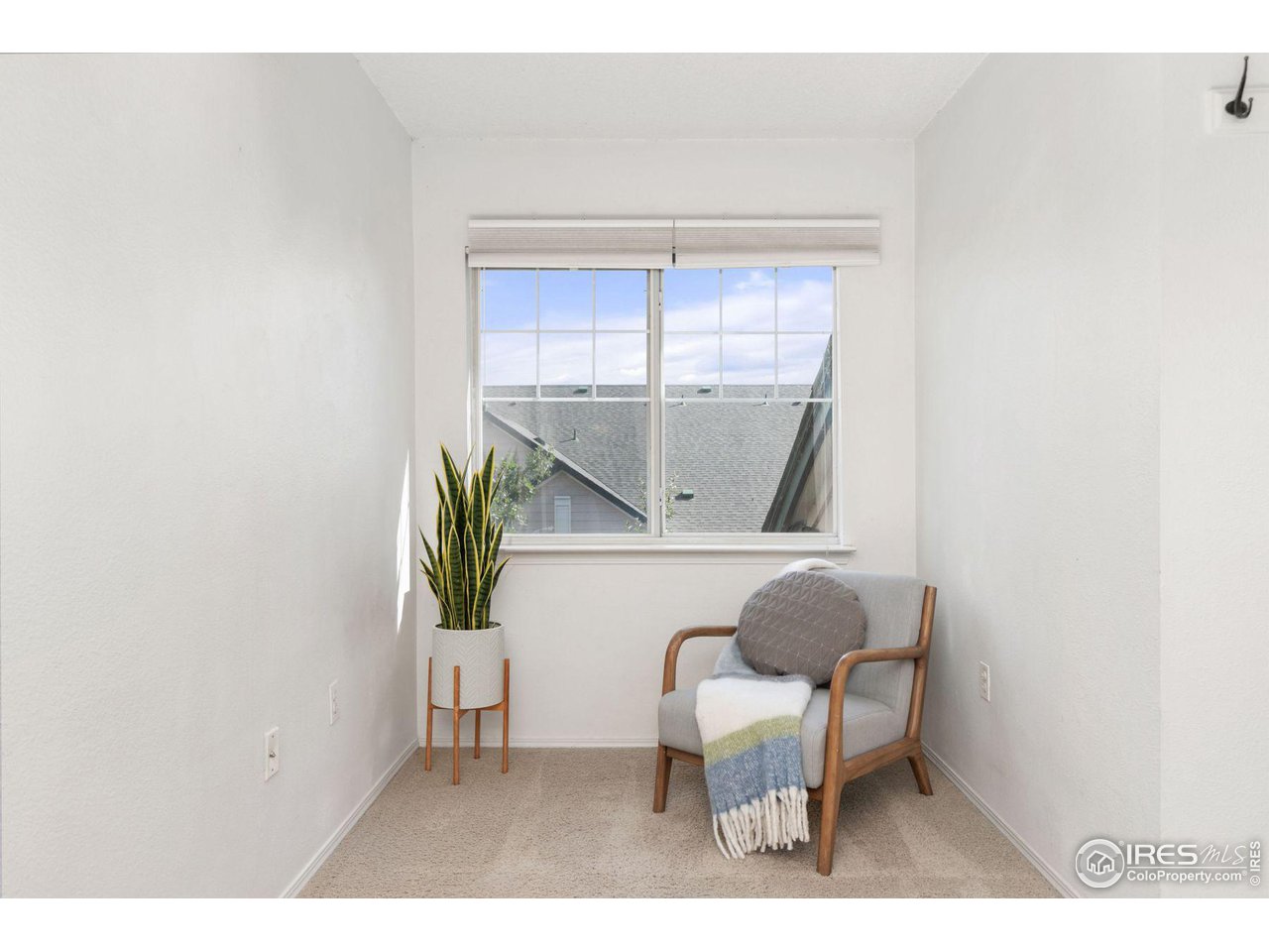 1855 Spaulding Circle Superior, CO 80027 - Photo 10 of 32 a living room with a chair and a potted plant