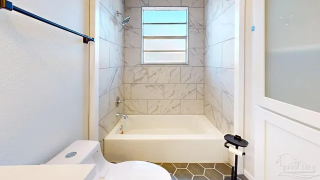 a bathroom with a bathtub and shower