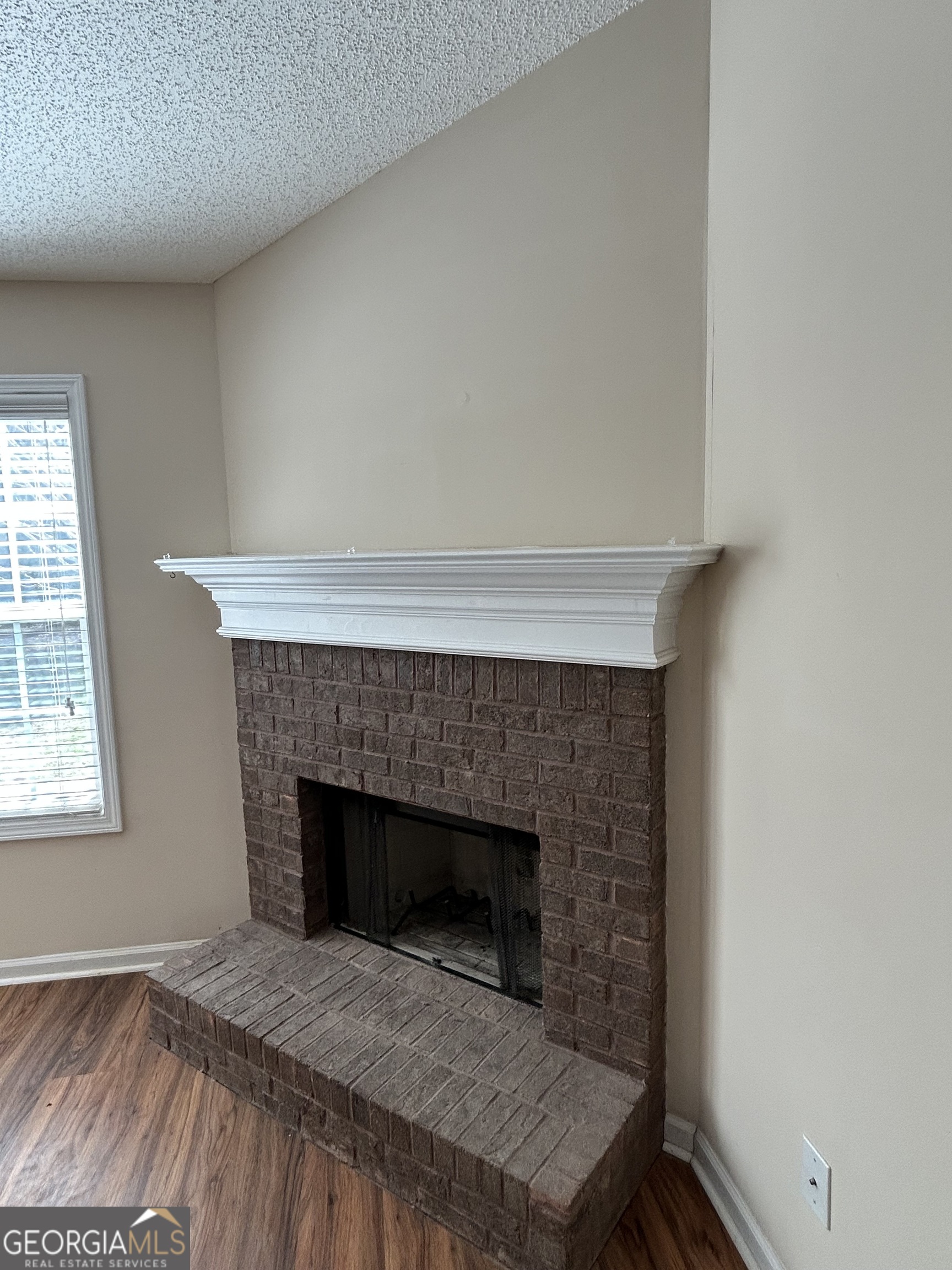 28 Pinewood Circle Colbert, GA 30628 - Photo 11 of 44 a living room with a fireplace and a table