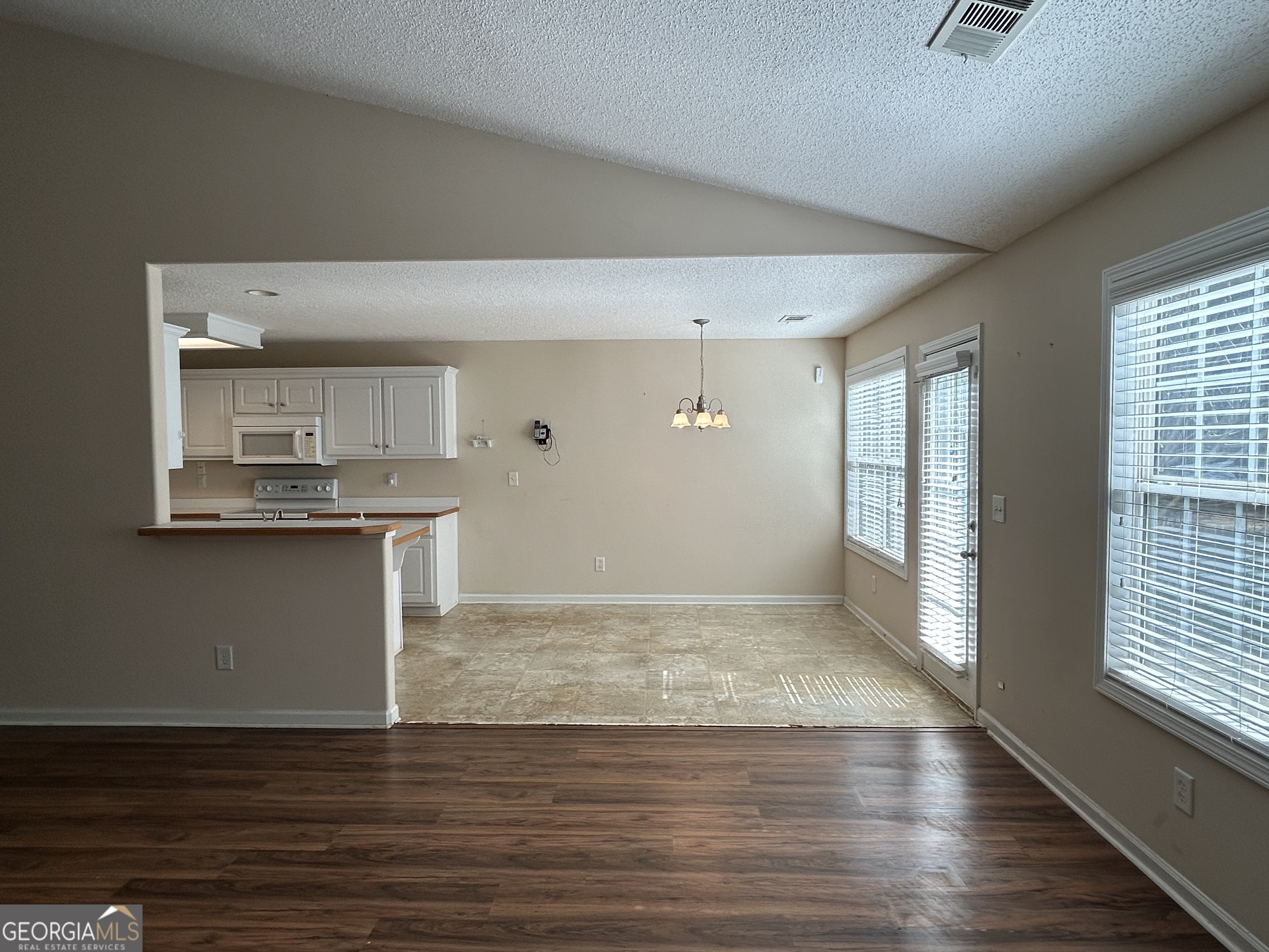 28 Pinewood Circle Colbert, GA 30628 - Photo 12 of 44 an empty room with wooden floor and windows