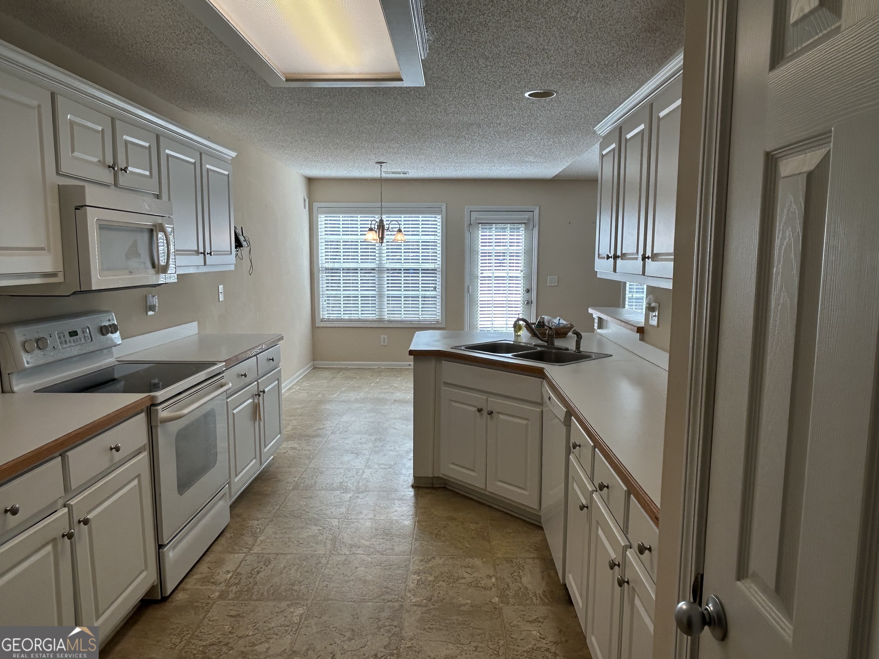 28 Pinewood Circle Colbert, GA 30628 - Photo 16 of 44 a kitchen with granite countertop a sink and cabinets