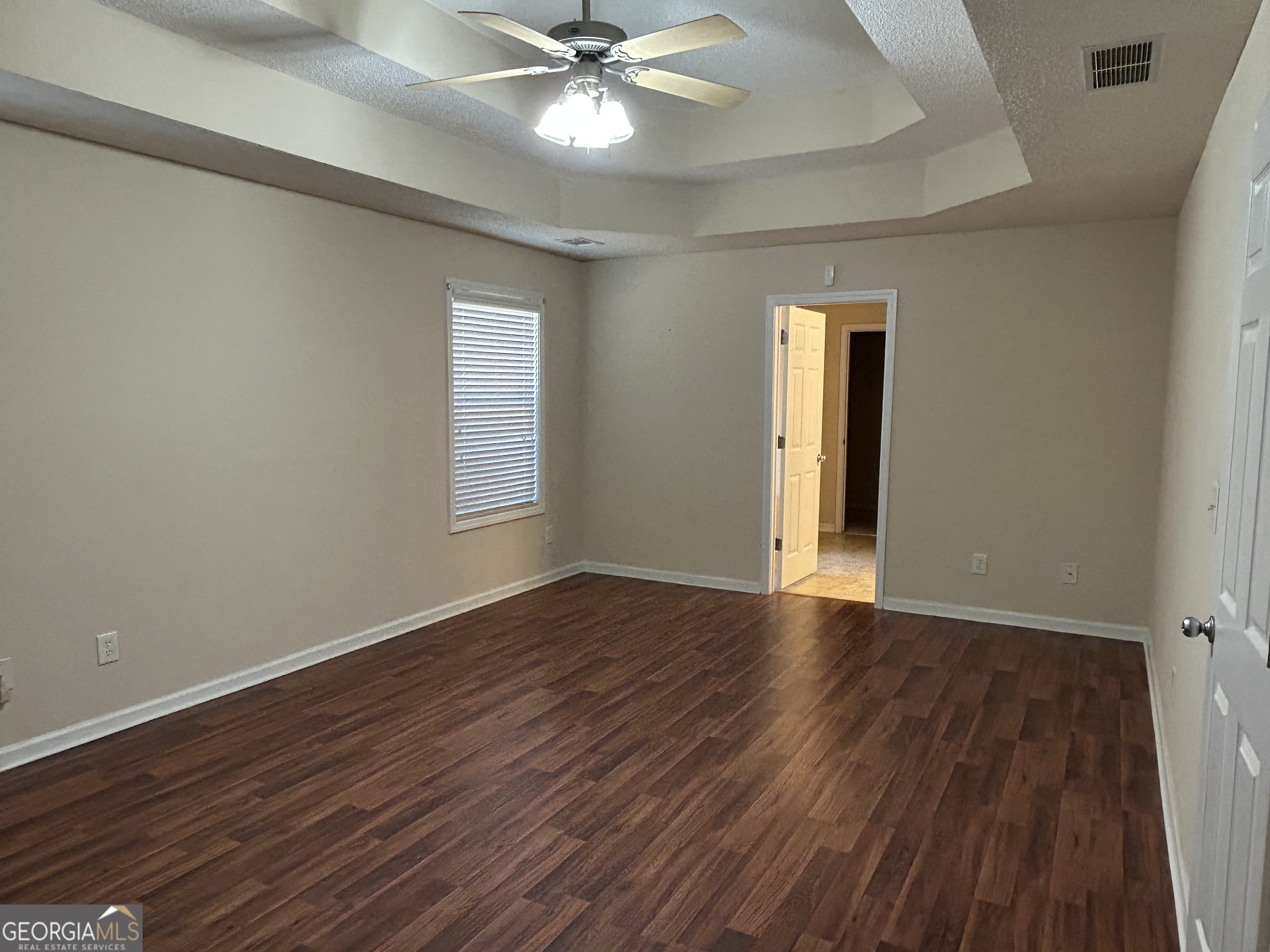 28 Pinewood Circle Colbert, GA 30628 - Photo 19 of 44 a view of an empty room with wooden floor and a window