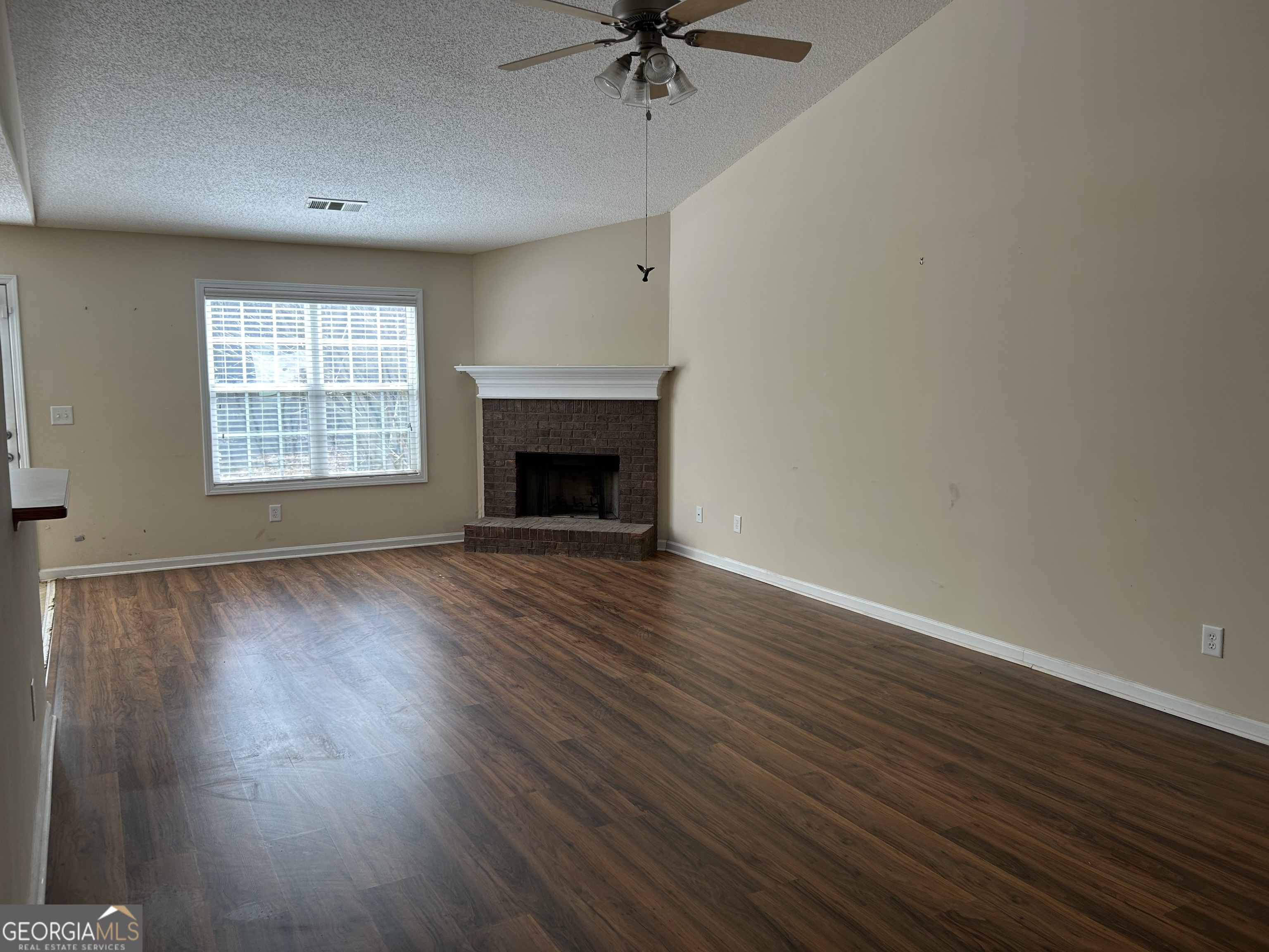 28 Pinewood Circle Colbert, GA 30628 - Photo 8 of 44 an empty room with windows and a fireplace