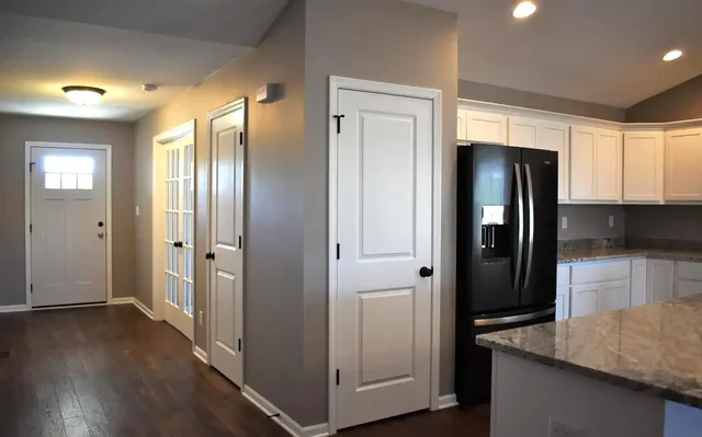 a kitchen with stainless steel appliances granite countertop a refrigerator and a stove