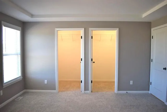 a view of an empty room with closet area