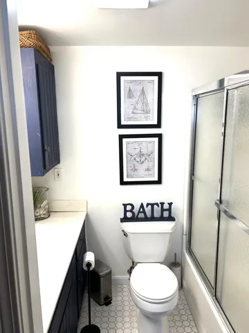 a bathroom with a toilet a sink and a mirror