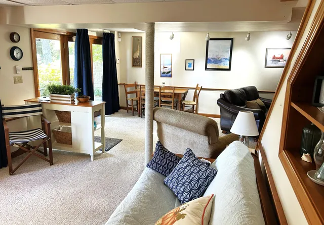 a living room with furniture and large windows