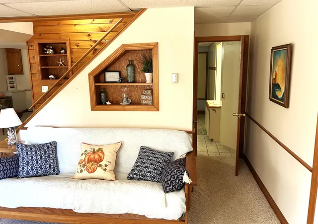 a living room with a couch and a potted plant