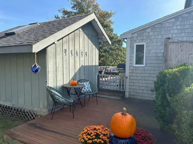 a backyard of a house with table and chairs