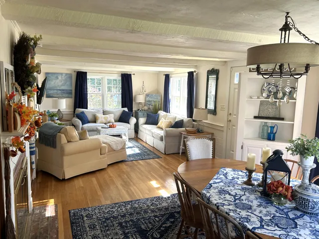 a living room with furniture a rug and a chandelier