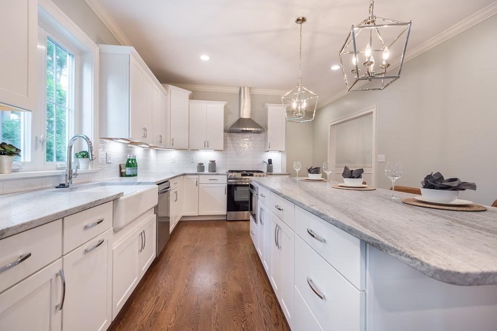 10 College Road Burlington, MA 01803 - Photo 12 of 37 a kitchen with kitchen island granite countertop stainless steel appliances cabinets a sink and a counter top space