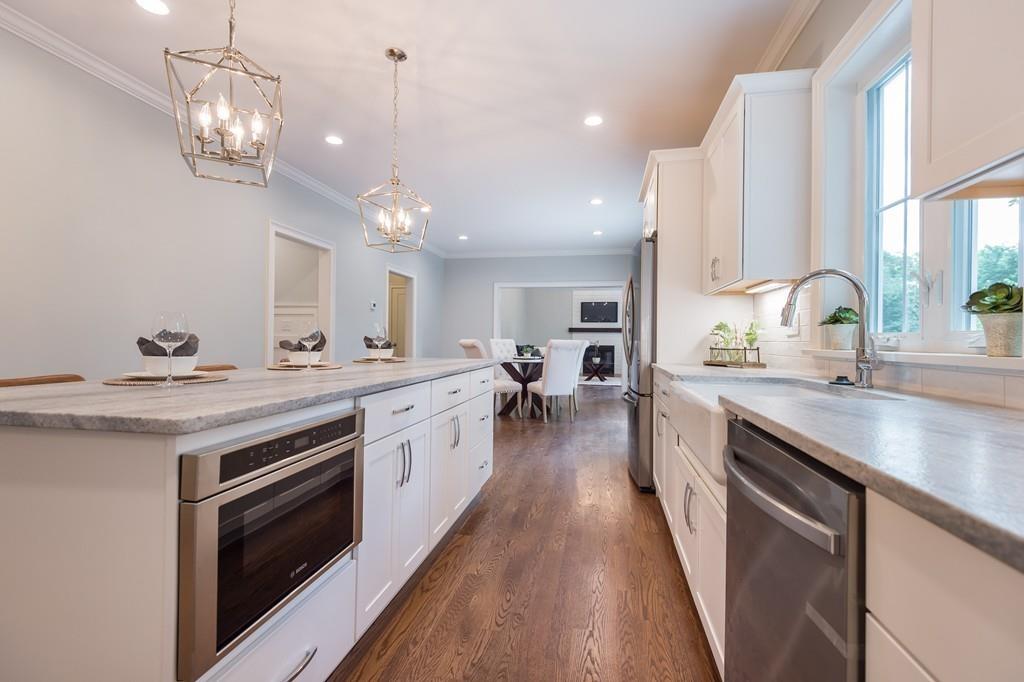 10 College Road Burlington, MA 01803 - Photo 14 of 37 a large kitchen with stainless steel appliances a lot of counter space and a chandelier