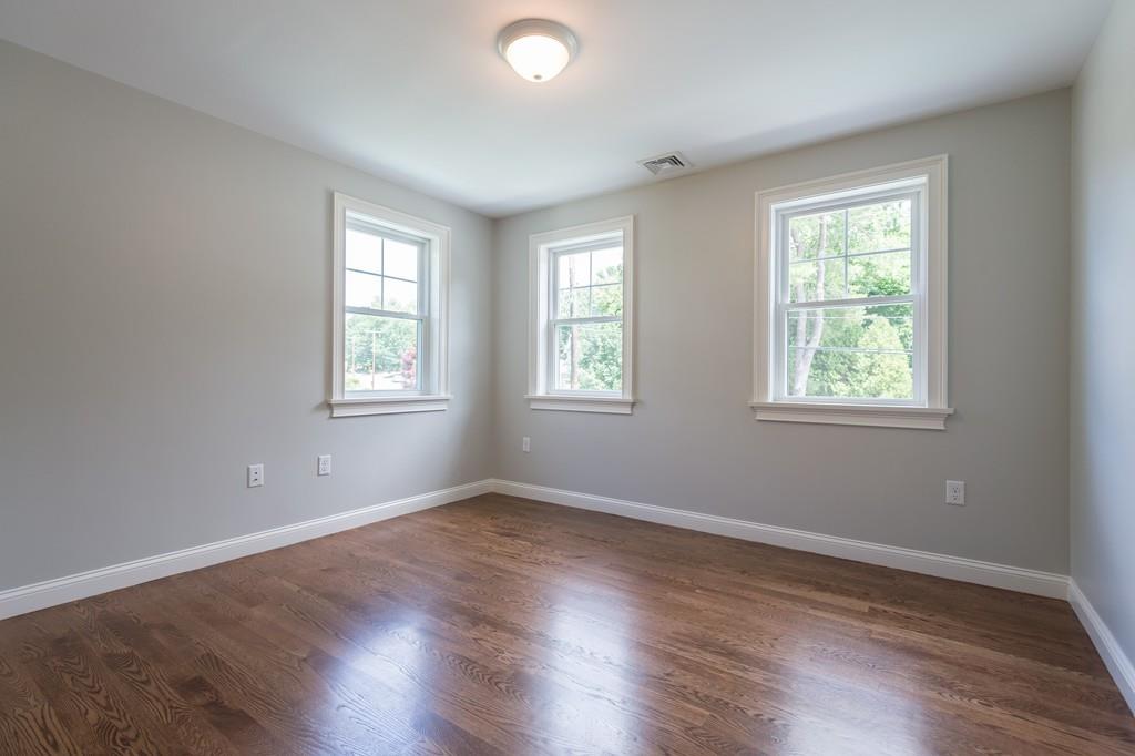 10 College Road Burlington, MA 01803 - Photo 26 of 37 a view of an empty room with wooden floor and a window