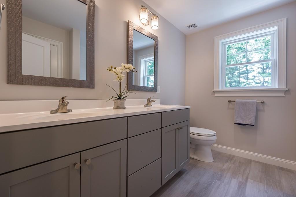 10 College Road Burlington, MA 01803 - Photo 28 of 37 a bathroom with a toilet sink and mirror