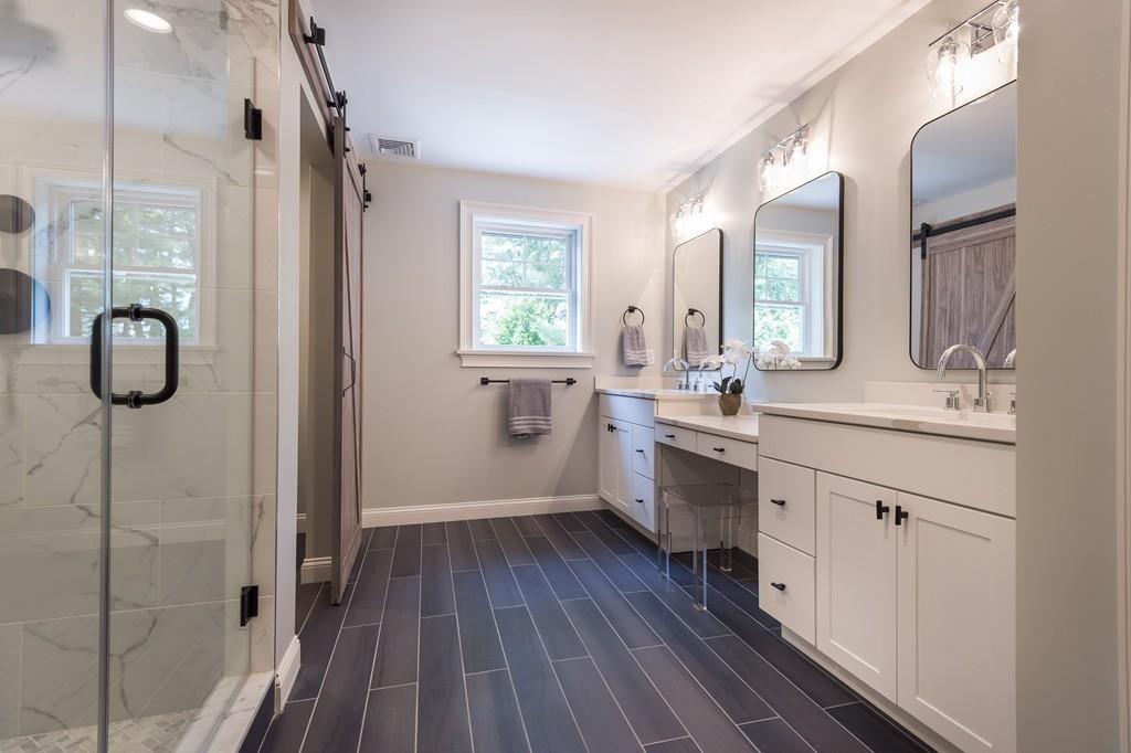10 College Road Burlington, MA 01803 - Photo 30 of 37 a bathroom with a granite countertop double vanity sink a mirror and a shower