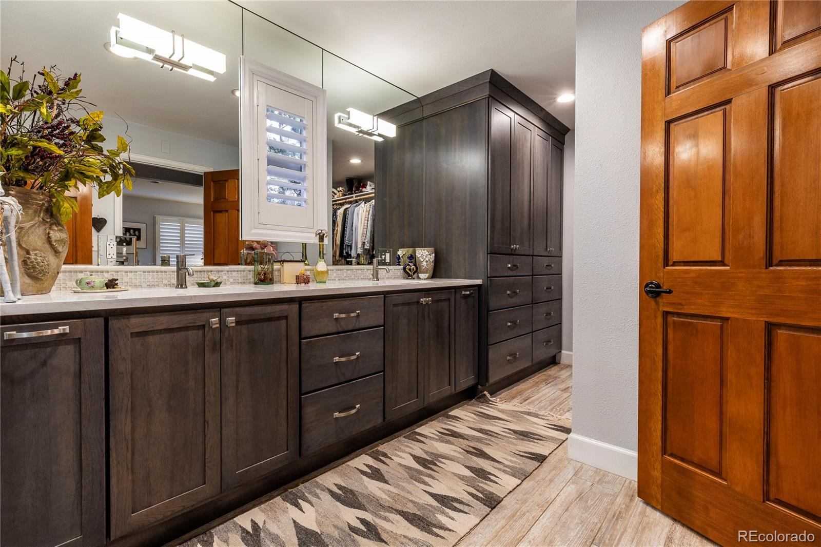 18975 Shadowood Drive Monument, CO 80132 - Photo 21 of 48 a spacious bathroom with a double vanity sink and a mirror