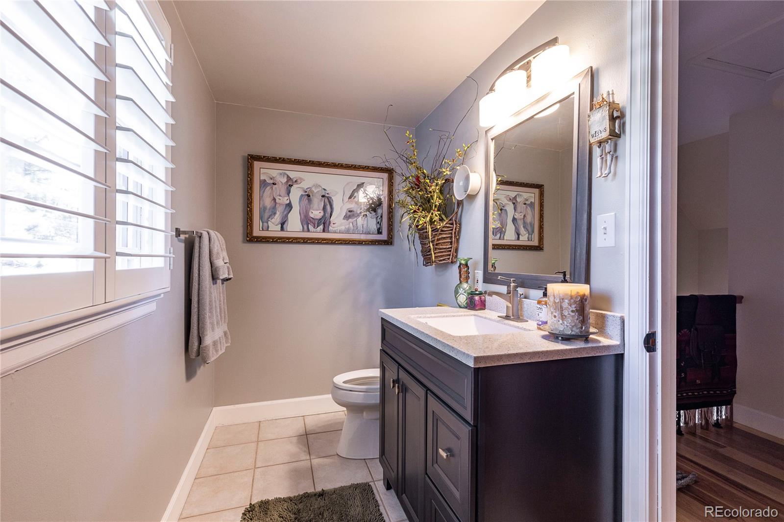 18975 Shadowood Drive Monument, CO 80132 - Photo 25 of 48 a bathroom with a sink and a mirror