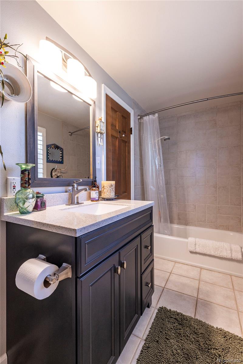 18975 Shadowood Drive Monument, CO 80132 - Photo 26 of 48 a bathroom with a sink and a mirror