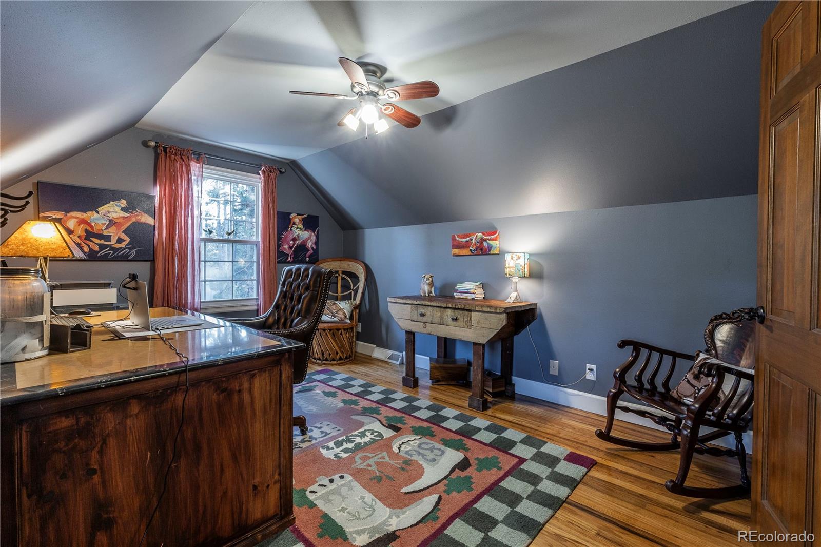 18975 Shadowood Drive Monument, CO 80132 - Photo 28 of 48 a living room with furniture a chandelier and a flat screen tv