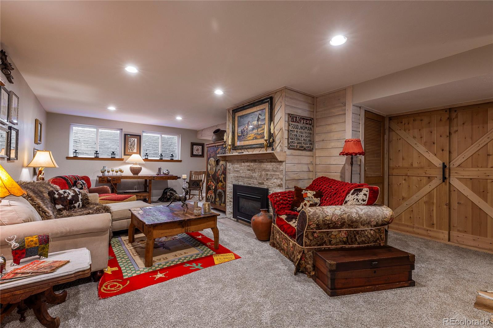 18975 Shadowood Drive Monument, CO 80132 - Photo 30 of 48 a living room with furniture and a fireplace