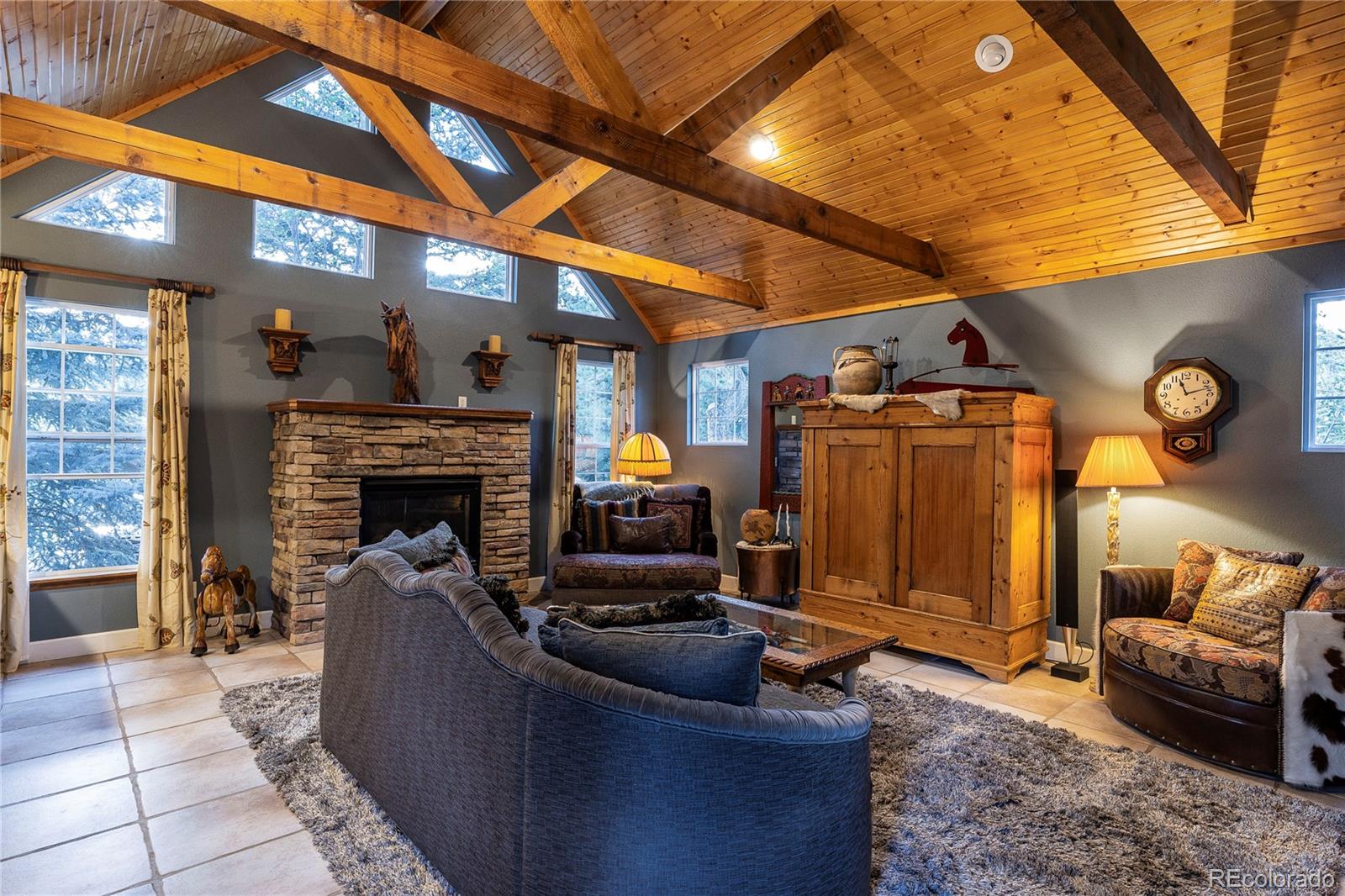18975 Shadowood Drive Monument, CO 80132 - Photo 3 of 48 a living room with furniture and a fireplace