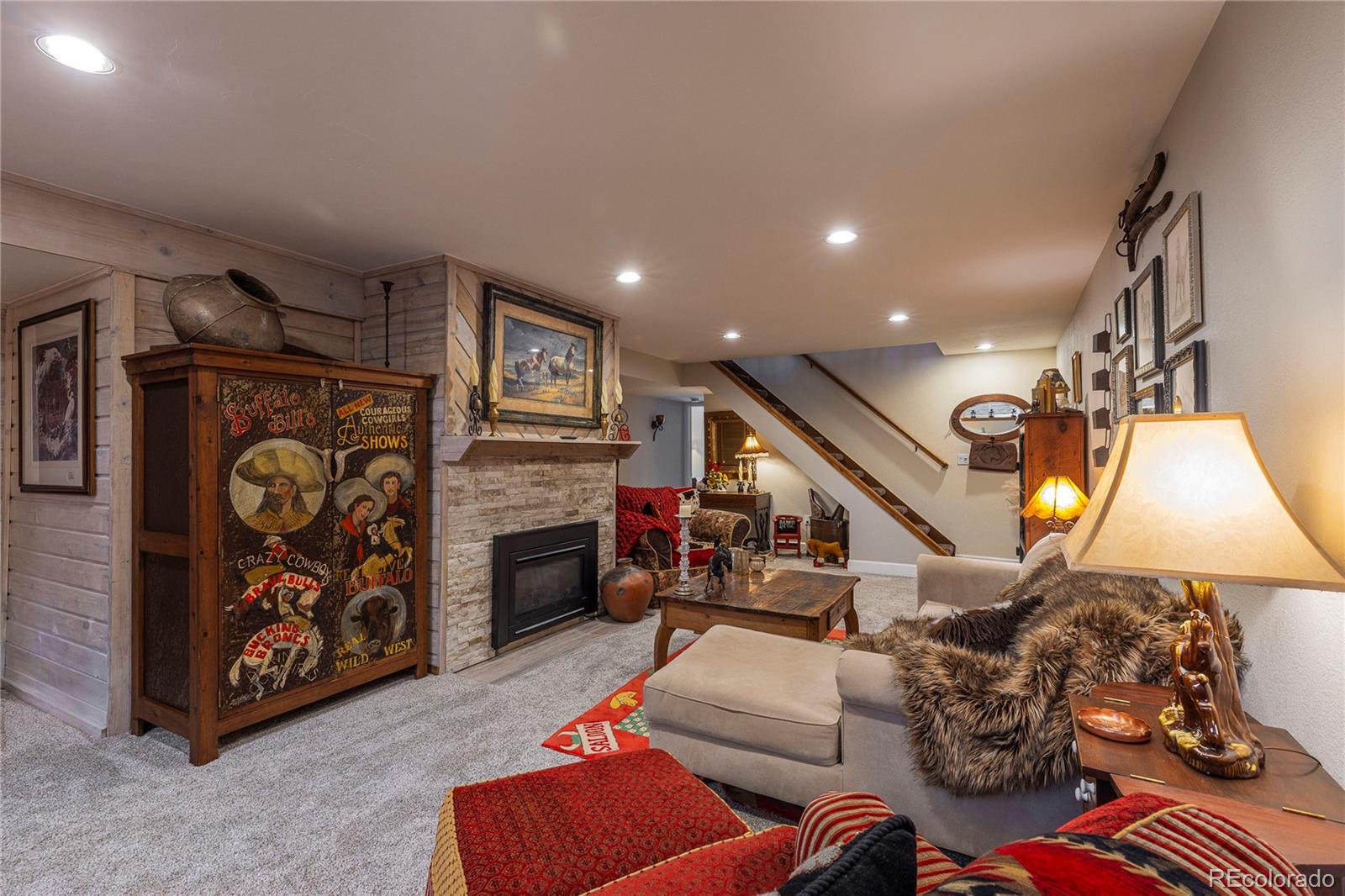 18975 Shadowood Drive Monument, CO 80132 - Photo 31 of 48 a living room with furniture and a flat screen tv
