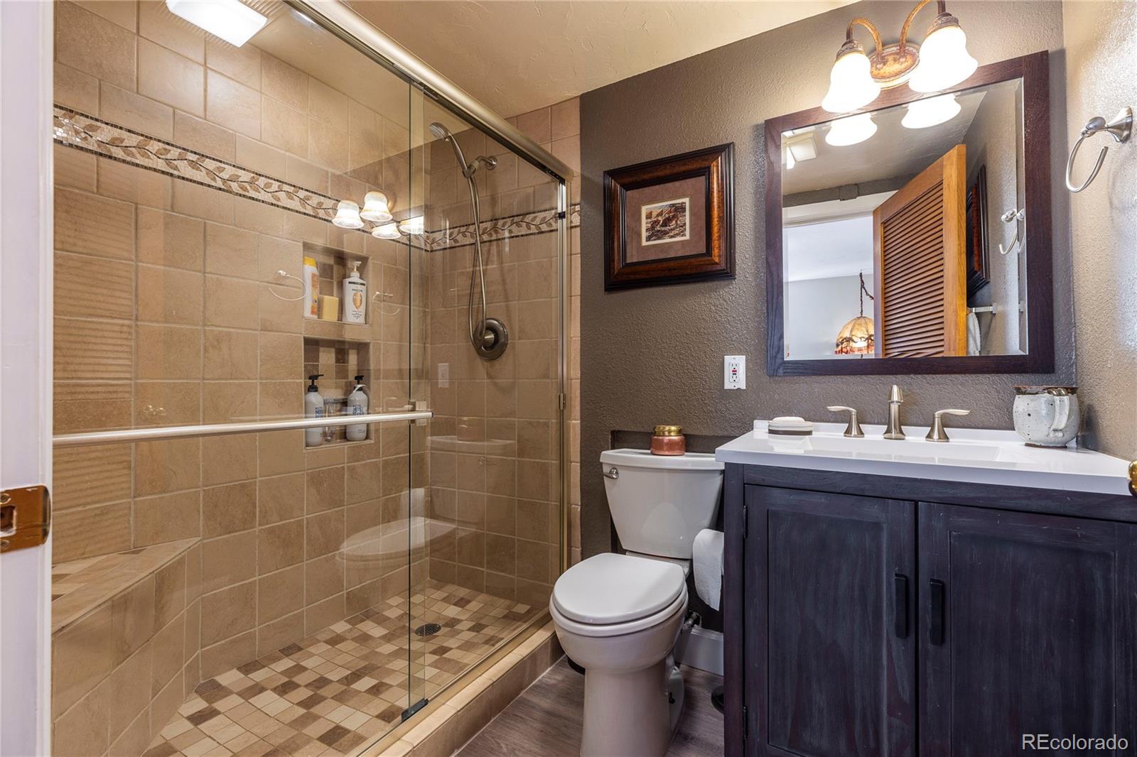 18975 Shadowood Drive Monument, CO 80132 - Photo 34 of 48 a bathroom with a sink toilet and shower