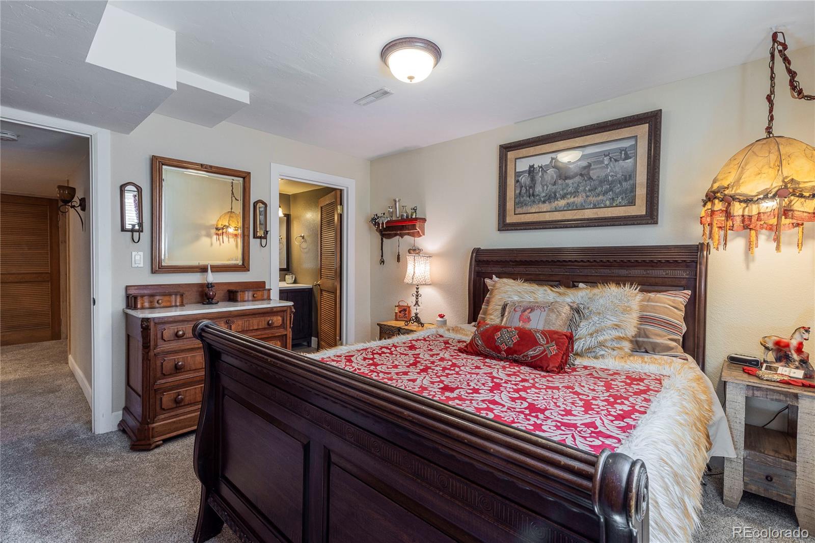 18975 Shadowood Drive Monument, CO 80132 - Photo 35 of 48 a bedroom with a bed and wooden floor