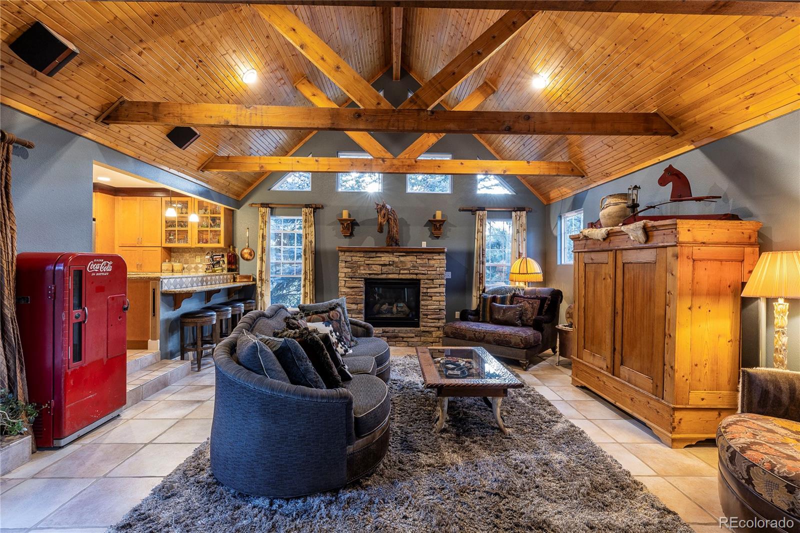 18975 Shadowood Drive Monument, CO 80132 - Photo 5 of 48 a living room with furniture a flat screen tv and a fireplace