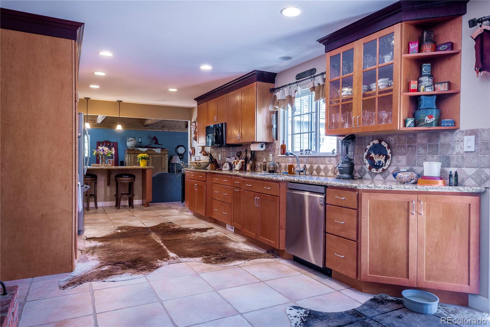 18975 Shadowood Drive Monument, CO 80132 - Photo 6 of 48 a kitchen with stainless steel appliances granite countertop a sink and cabinets