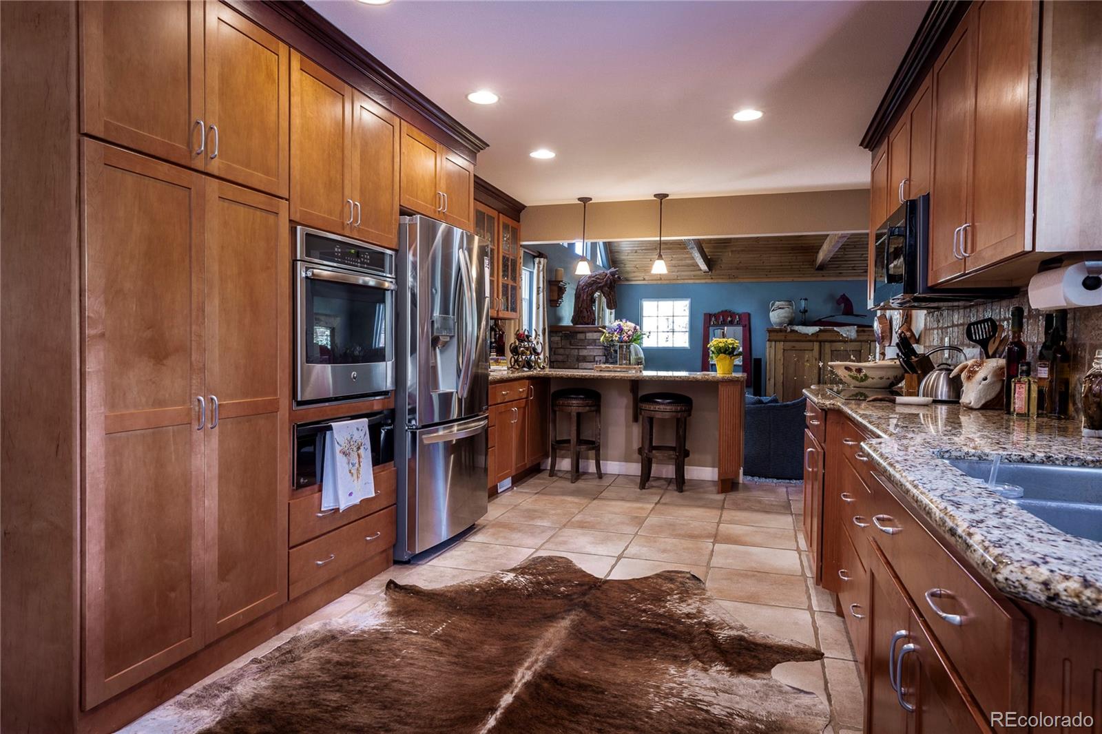 18975 Shadowood Drive Monument, CO 80132 - Photo 7 of 48 a kitchen with stainless steel appliances granite countertop a refrigerator and a stove top oven