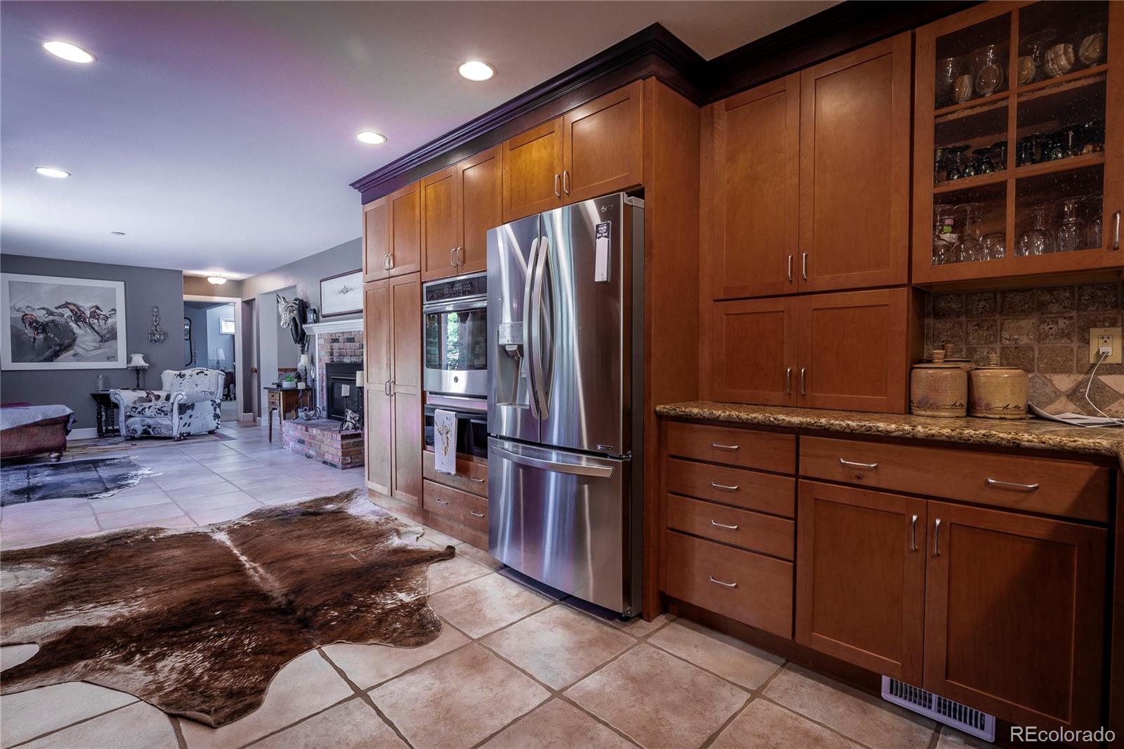 18975 Shadowood Drive Monument, CO 80132 - Photo 8 of 48 a kitchen with stainless steel appliances granite countertop a refrigerator and a sink