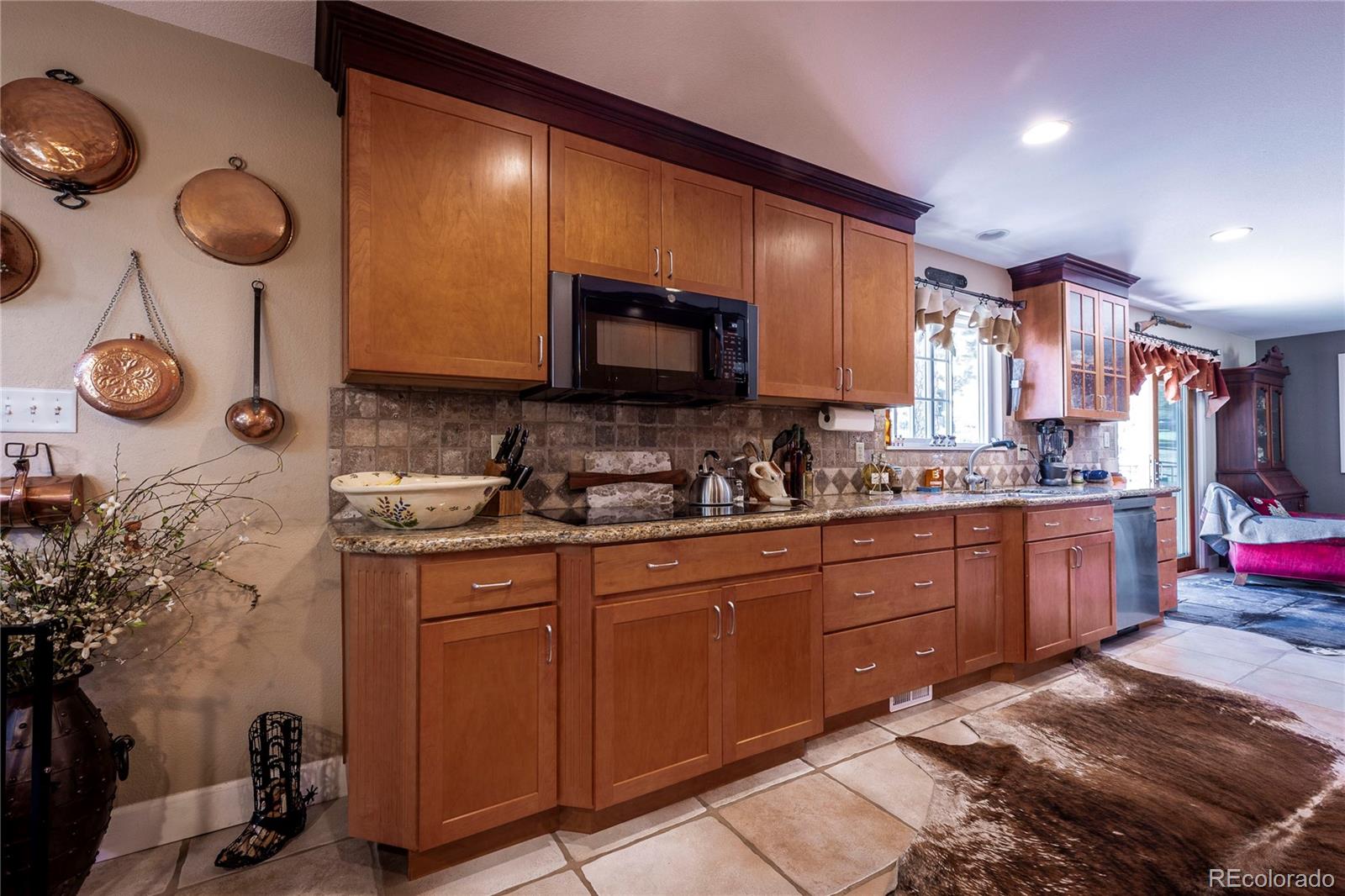 18975 Shadowood Drive Monument, CO 80132 - Photo 10 of 48 a kitchen with granite countertop a sink and a stove top oven