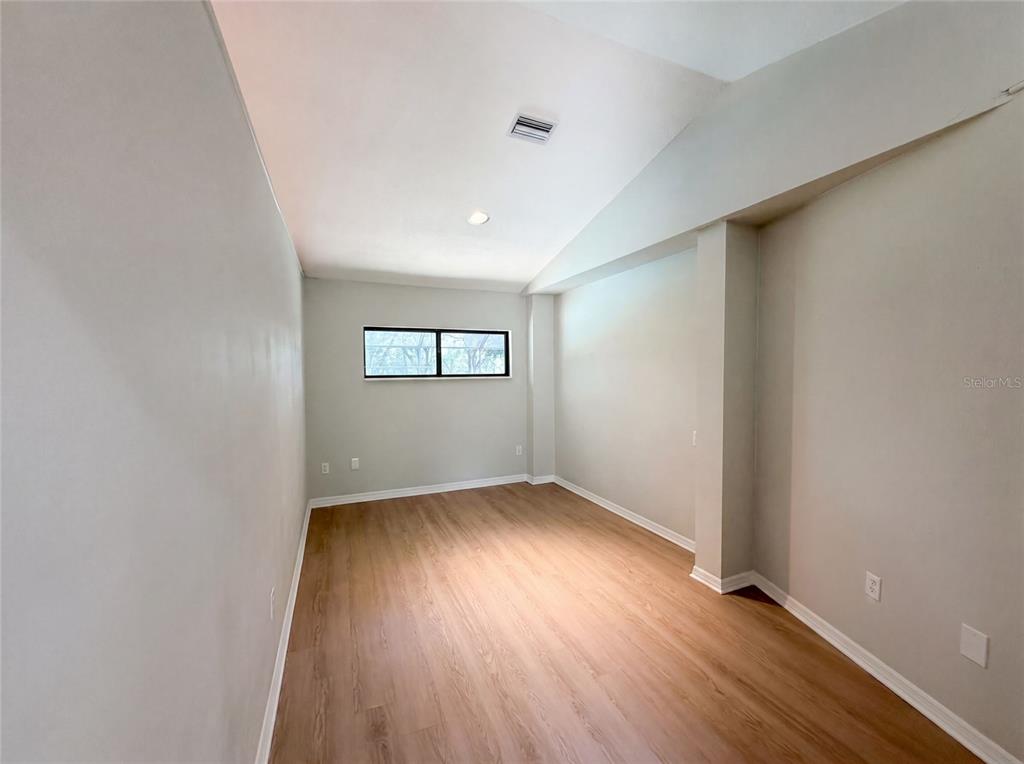 3739 Lake Griffin Road Lady Lake, FL 32159 - Photo 17 of 21 an empty room with wooden floor and windows