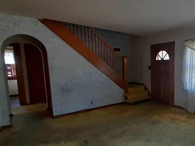 an empty room with a window and doors