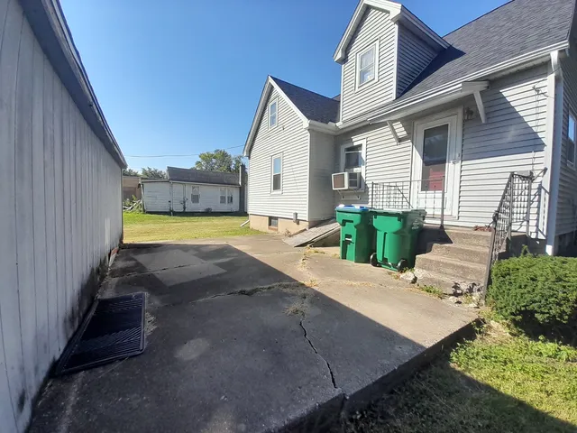 a view of an house with backyard space and balcony