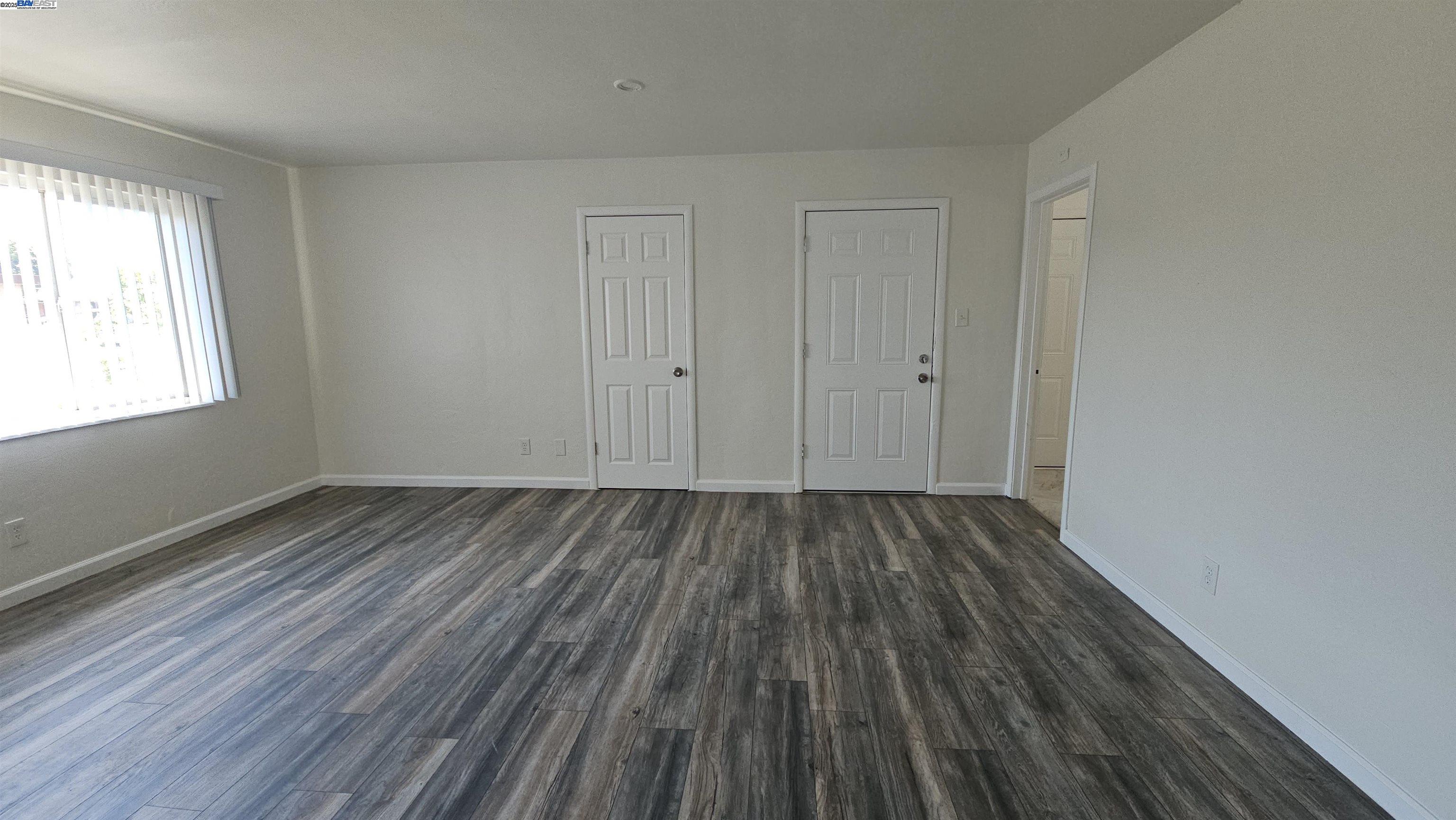 7448 Lockwood Street Oakland, CA 94621 - Photo 12 of 35 a view of a room with wooden floor and window