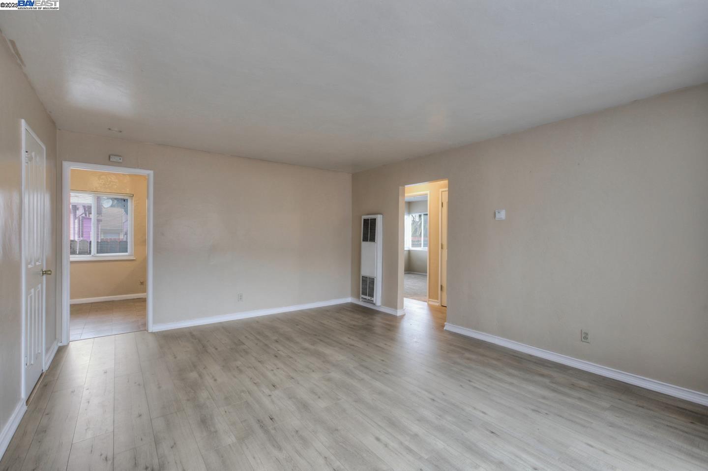 7448 Lockwood Street Oakland, CA 94621 - Photo 14 of 35 a view of an empty room with wooden floor and a window