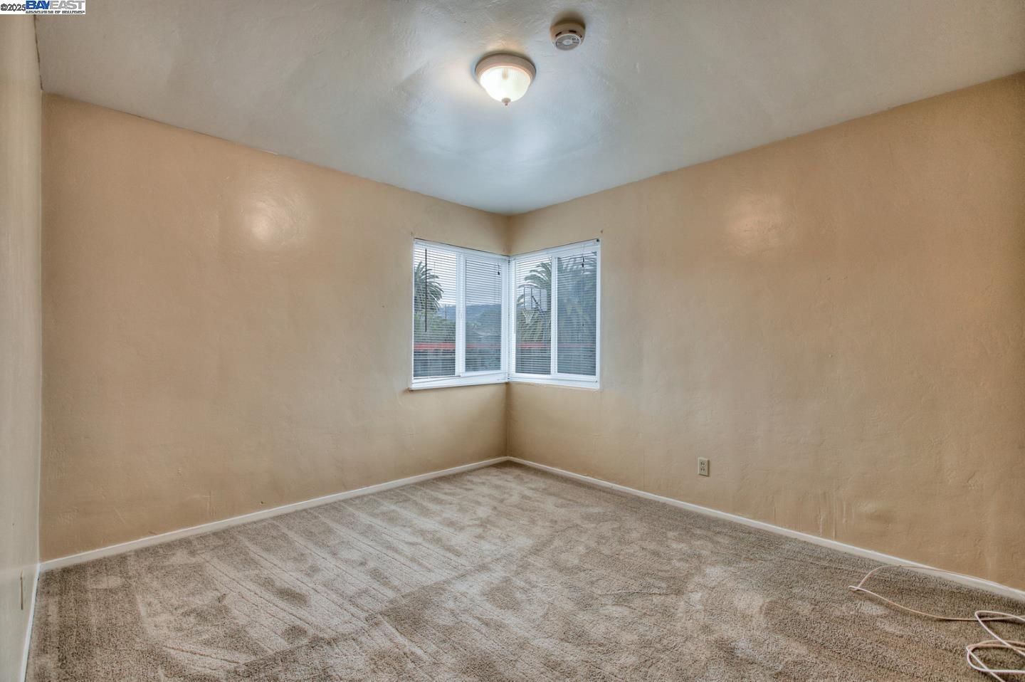 7448 Lockwood Street Oakland, CA 94621 - Photo 25 of 35 an empty room with windows and closet