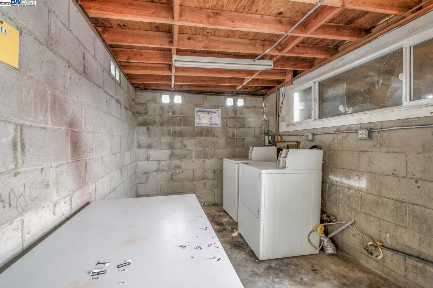 7448 Lockwood Street Oakland, CA 94621 - Photo 28 of 35 a utility room with a wooden floor