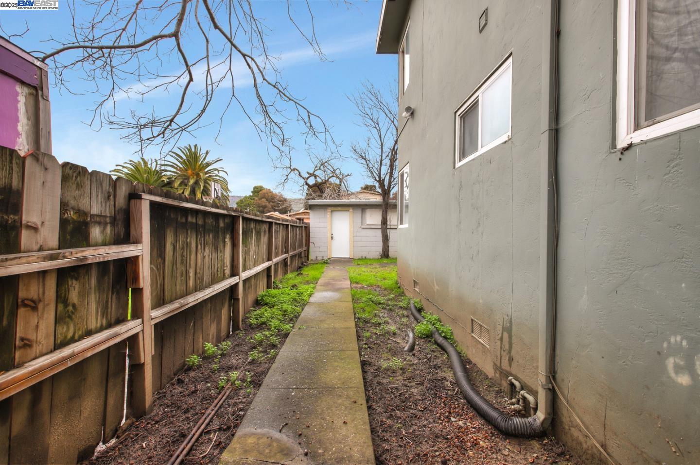 7448 Lockwood Street Oakland, CA 94621 - Photo 30 of 35 a view of a pathway of a house with wooden fence