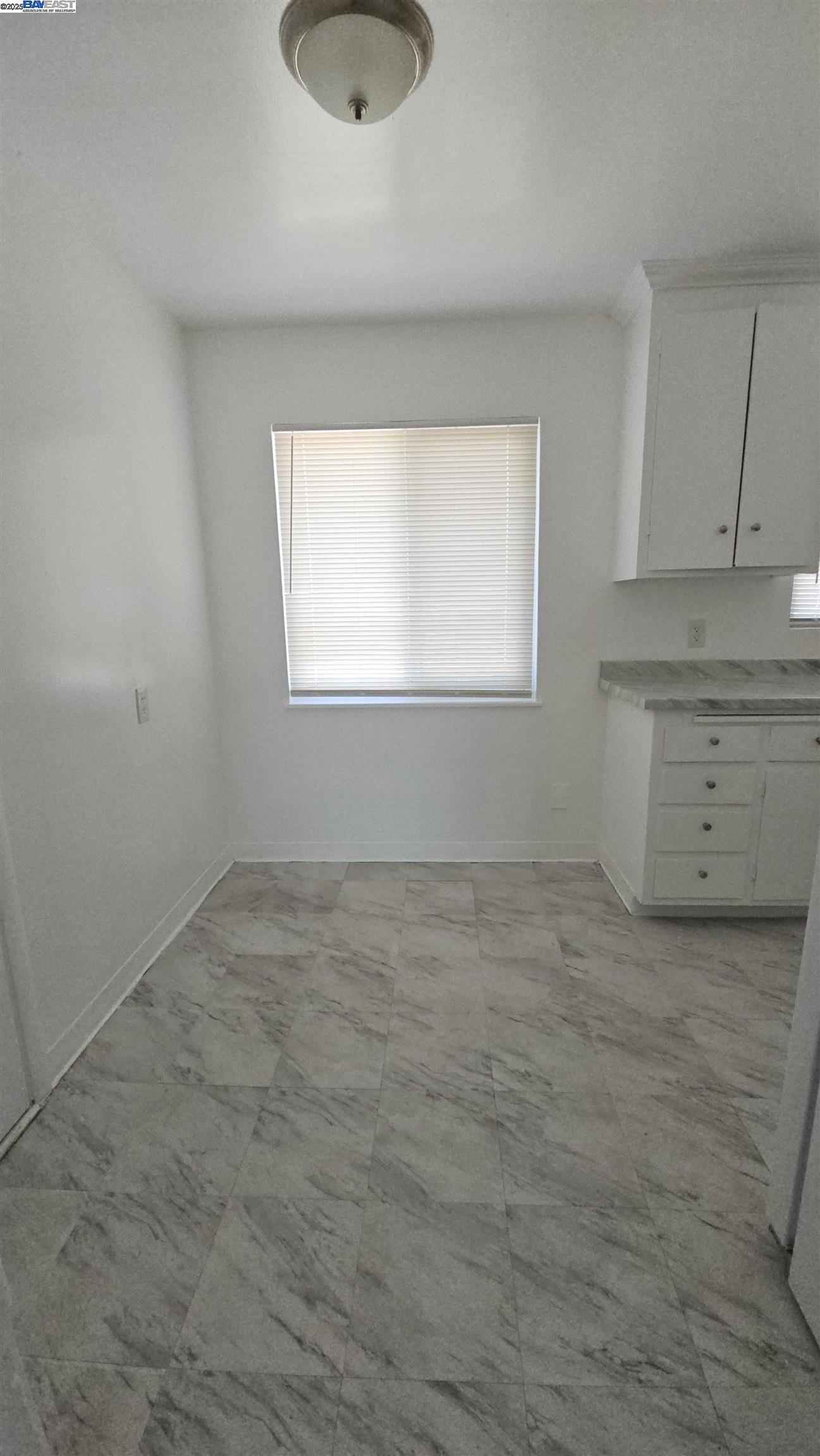 7448 Lockwood Street Oakland, CA 94621 - Photo 9 of 35 an empty room with a window