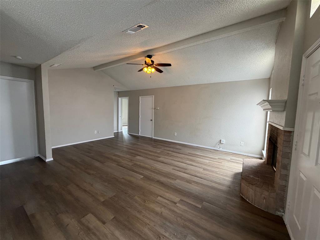 7401 Wagonwheel Road Fort Worth, TX 76133 - Photo 2 of 9 wooden floor in an empty room with a window