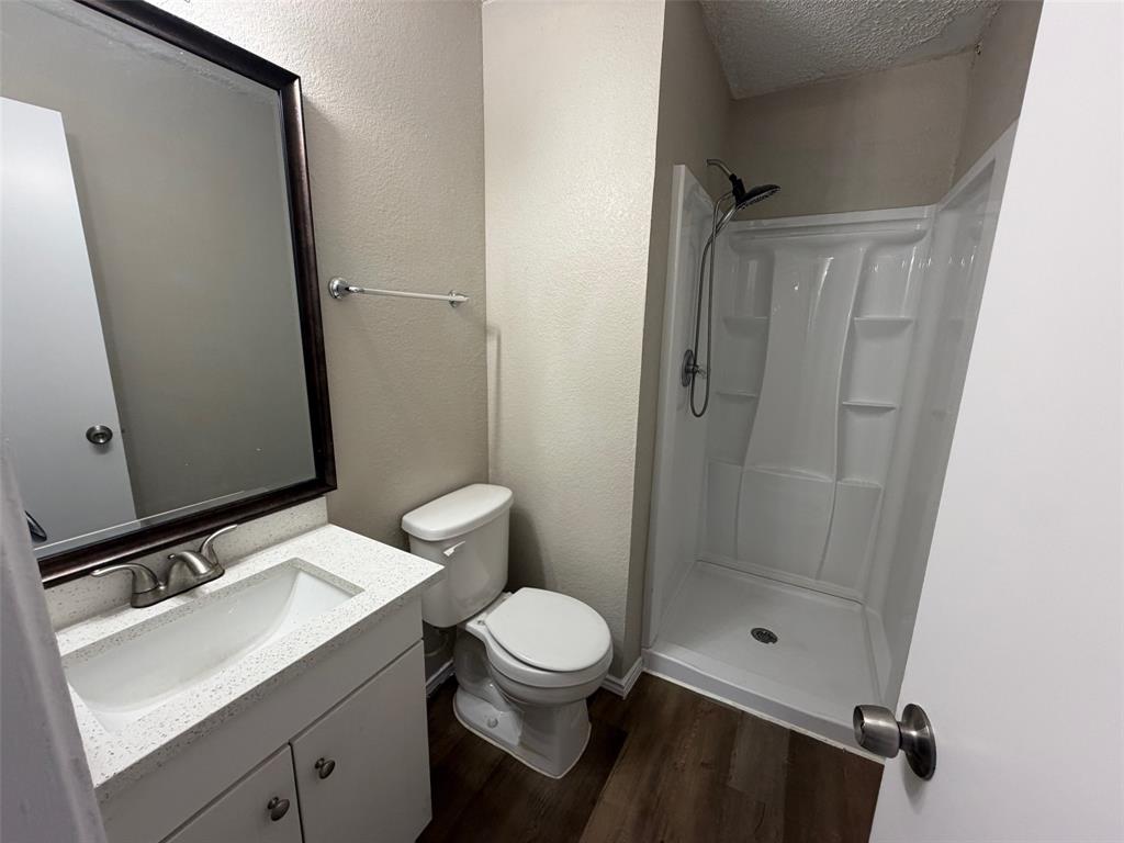 7401 Wagonwheel Road Fort Worth, TX 76133 - Photo 5 of 9 a bathroom with a granite countertop sink toilet and shower