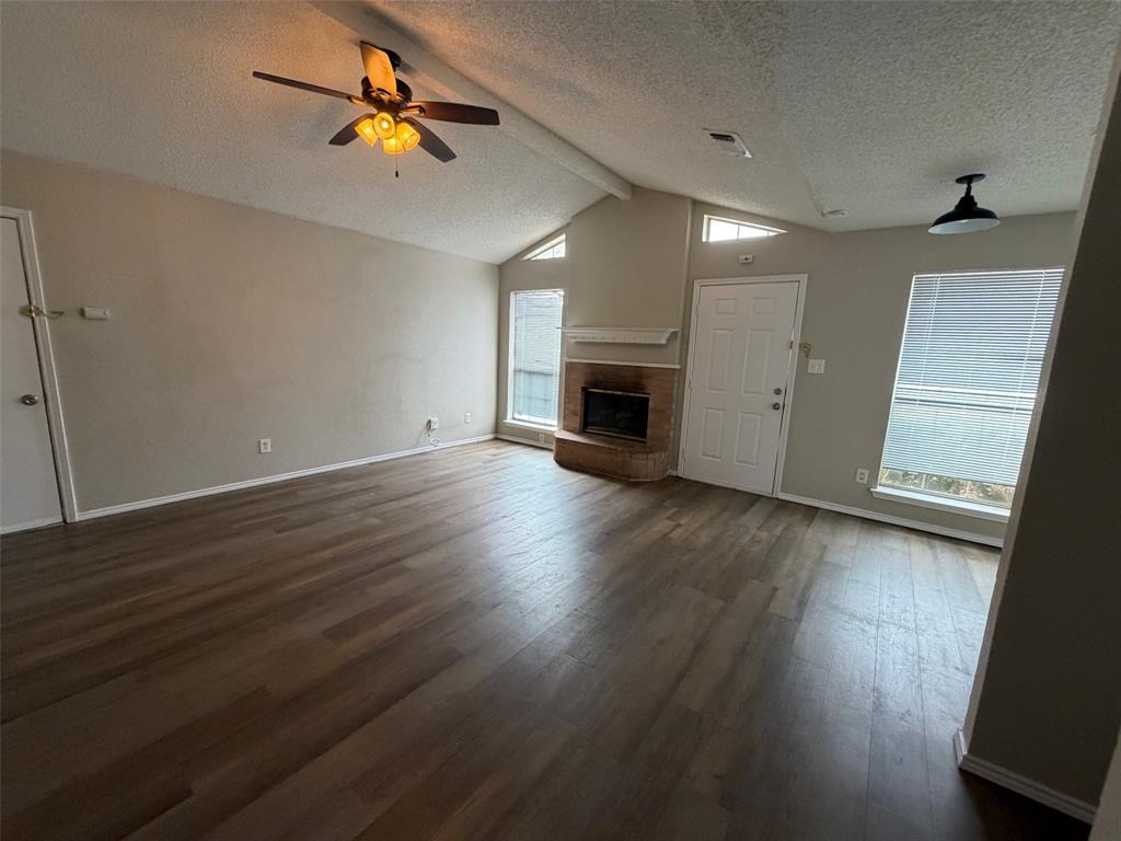 7401 Wagonwheel Road Fort Worth, TX 76133 - Photo 6 of 9 a view of empty room with wooden floor and fan