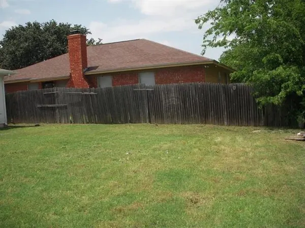 a front view of house with yard and trees