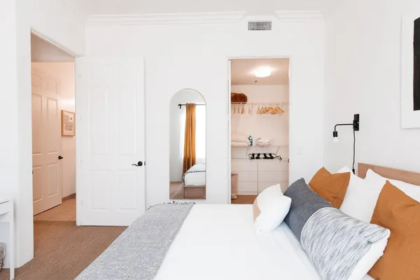 a bedroom with a bed and a walk in closet