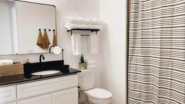 a bathroom with a sink a toilet and shower curtain