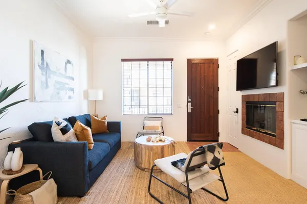 a living room with furniture fireplace and a flat screen tv