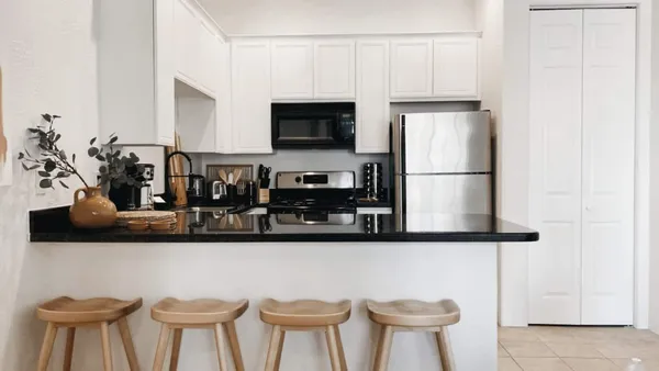 a kitchen with stainless steel appliances a refrigerator and cabinets